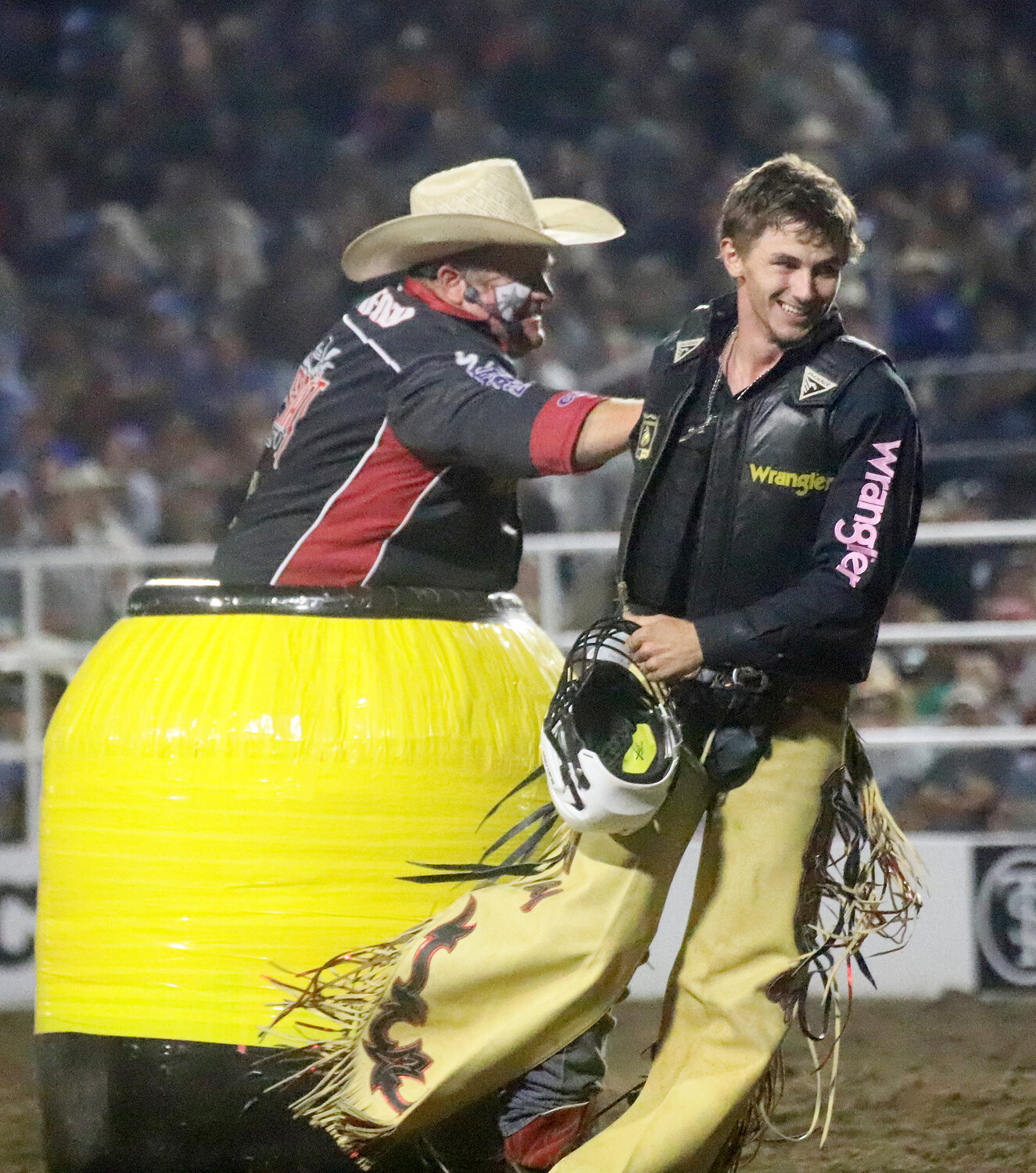 National Rodeo Clown Justin Rumford congratulates Creek Young after a wild 90.5 ride Wednesday night at the Tri-State Rodeo's Jim Baier/Dodge Ram Chute Out in Fort Madison.