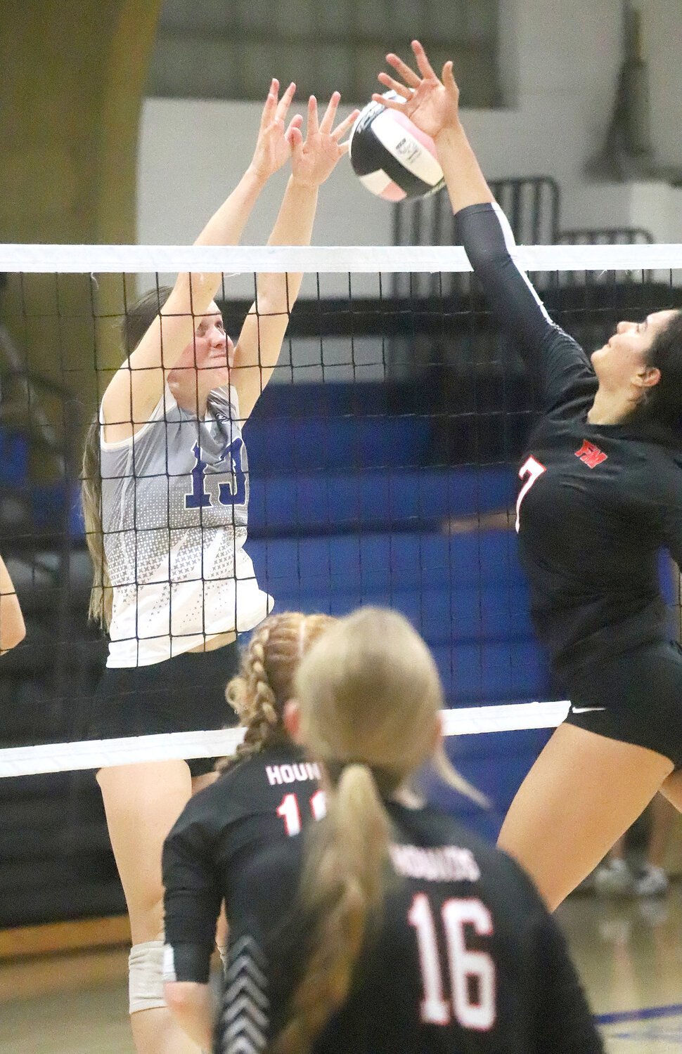 Holy Trinity Catholic's Mary Kate Bendlage and Fort Madison's Dayonna Davis (right) battle for a ball at the net in late action Monday at the Holy Trinity Classic. HTC won the title going 4-0.