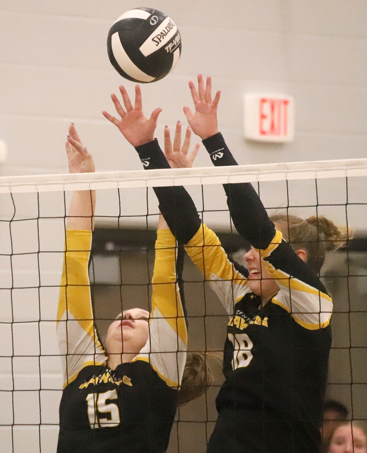 Junior's Ellie Lake and Taylor Jones put up a block on an attack against New London late Thursday night at Central Lee.