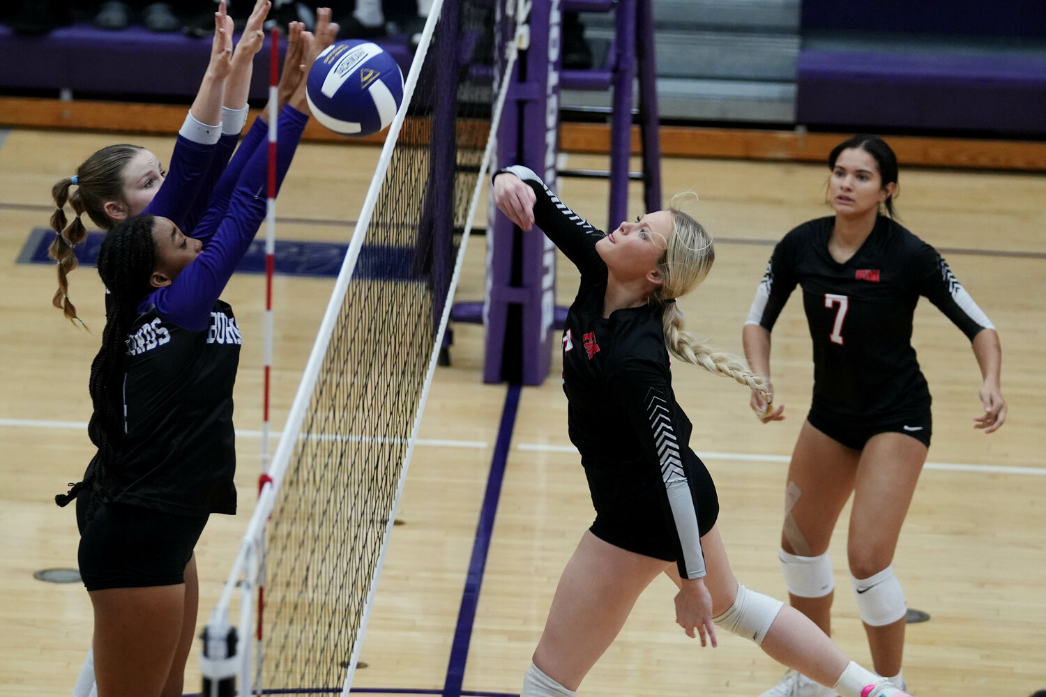 Fort Madison High School's Taylor Johnson (5) puts the ball over the net during the second set of their match against Burlington High School, Tuesday, September 26 at Burlington's Carl Johannsen Gymnasium.