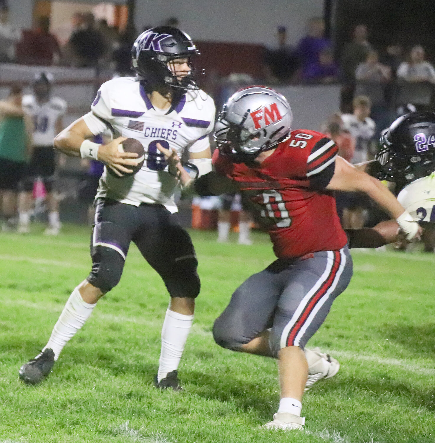 Senior Ike Thacher gives chase to Fort Madison's Brenton Hoard in the first quarter of the Hounds' win Friday night.