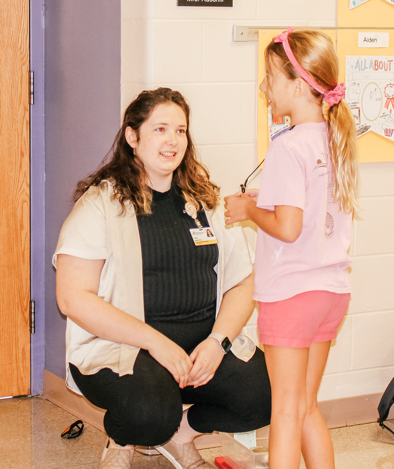 Trudy Jacobs, an Educational Audiology Intern from the University of Iowa talks with a student during a session earlier this month.