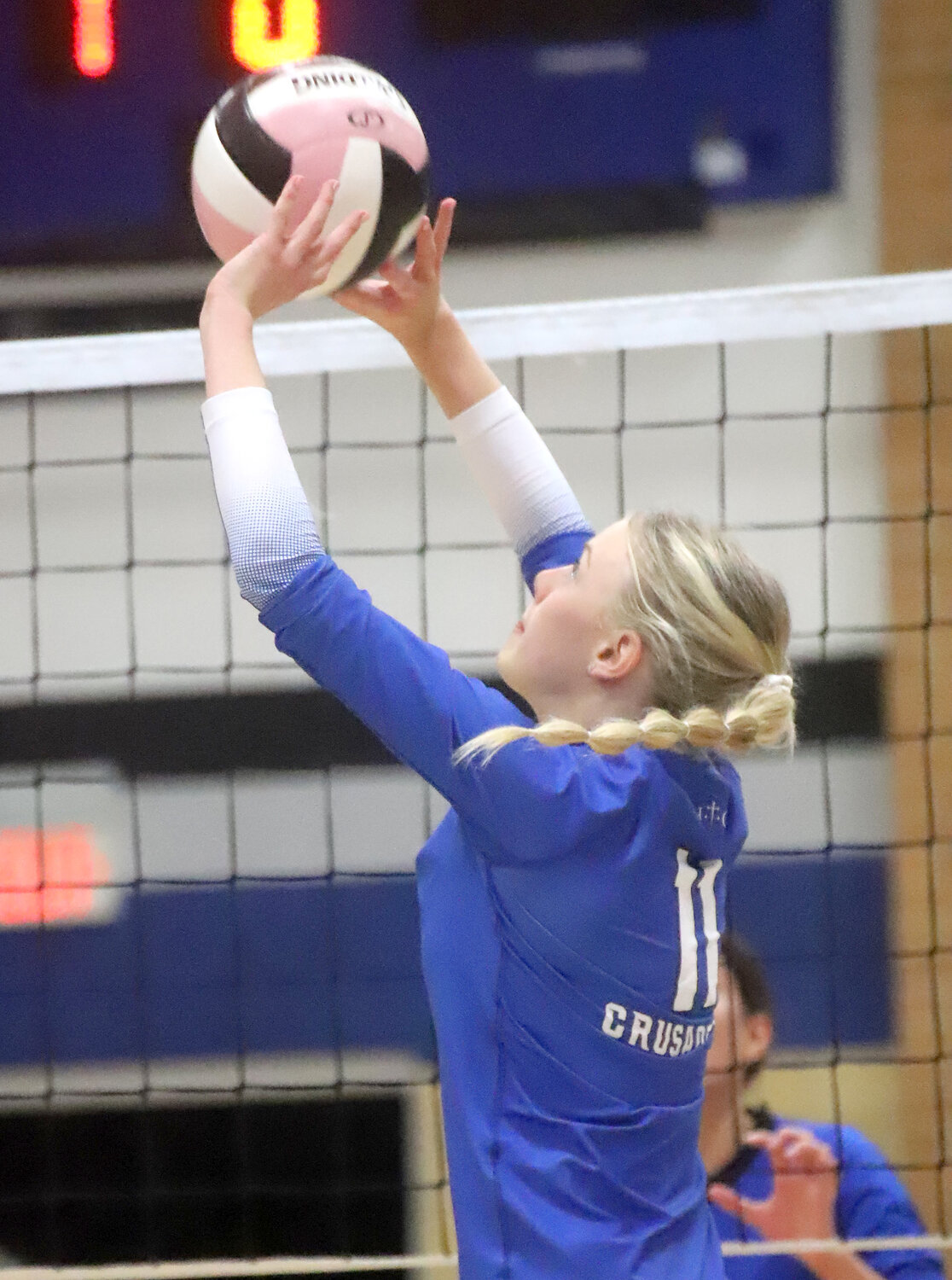 Senior Natalie Randolph works up an assist in the second set Wednesday night. Randolph and the Crusaders rolled to a 3-set win over Danville in Fort Madison.