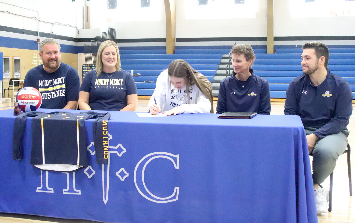 HTC senior Mary Kate Bendlage signs a letter with Mt. Mercy University to play volleyball for the Mustangs Wednesday in Fort Madison.