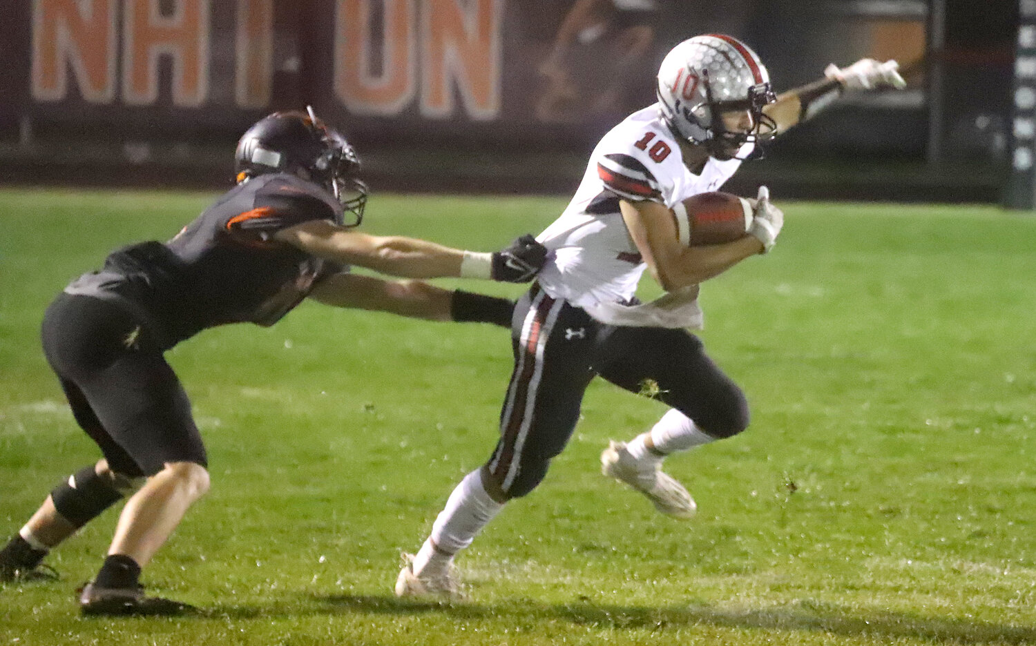 Senior Leif Boeding tries to pull away from would-be tackler after pulling in a screen pass from Marcus Guzman. Boeding would finish with 40 yards on three catches in the win.