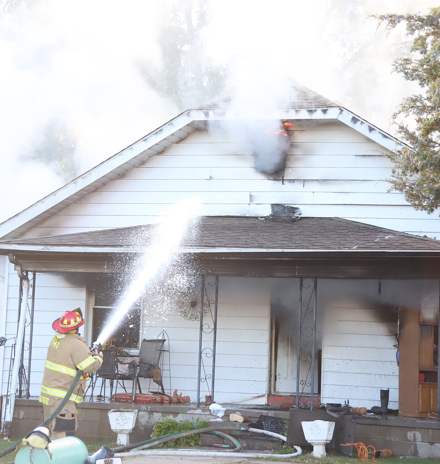 FM firefighters work on the front of a home in the 3400 block of Avenue N Sunday morning. The home caught fire at about 7:30 in the morning Sunday in Fort Madison.