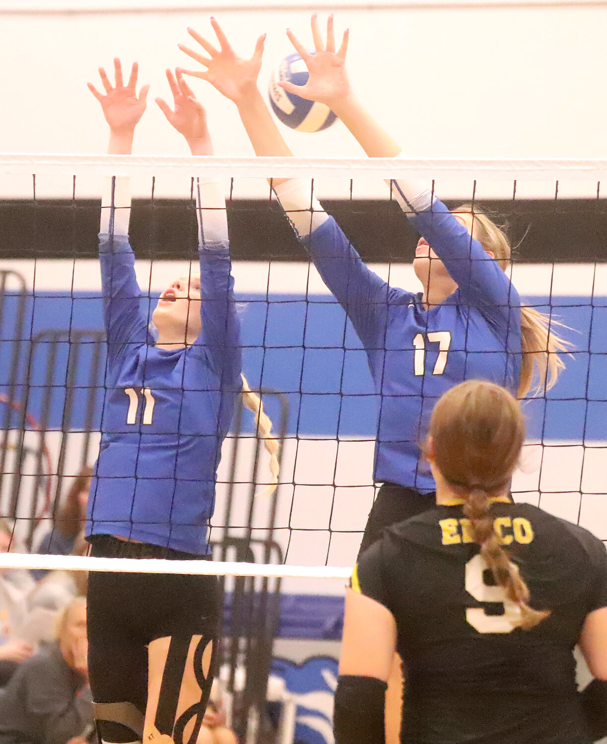 Sophomore Presley Myers and Natalie Randolph put up a block last week in the regional championship in West Liberty. The Crusaders start state tournament play Tuesday against Don Bosco at the Xtreme Arena.