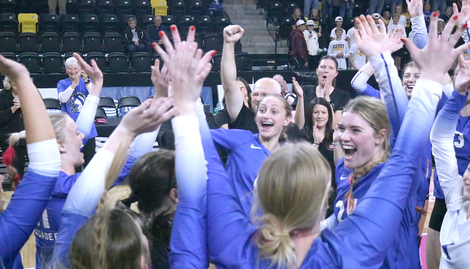 The Lady Crusaders celebrate their second sweep of the IGHSAU State Volleyball Tournament Wednesday at the Xtreme Arena in Coralville.
