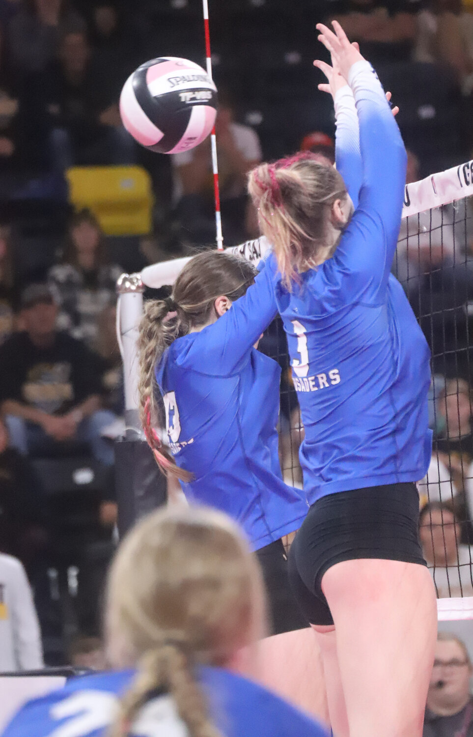 HTC freshman Adalyn Kruse and senior Mary Kate Bendlage put up a block in the first set of the Crusaders semifinal win over Boyden-Hull Wednesday in Coralville.