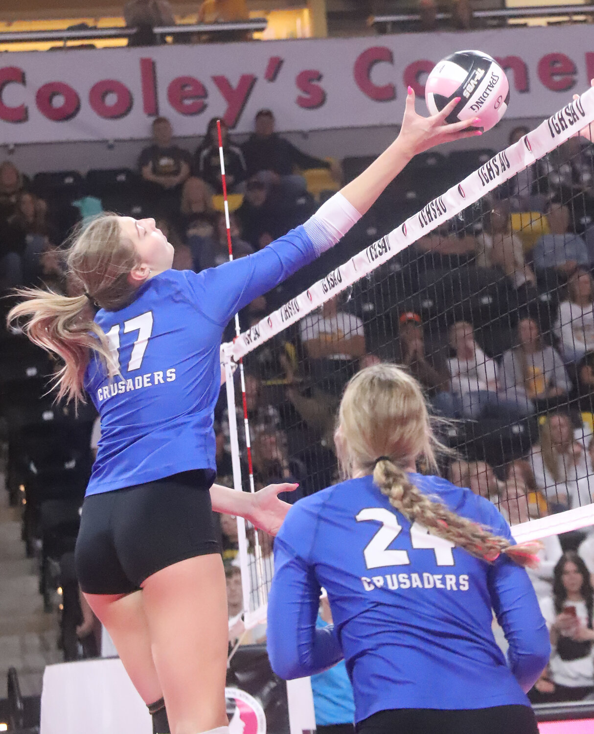 Sophomore Presley Myers tips a ball over the net from the middle hitter spot as Holy Trinity rolled over Boyden-Hull Wednesday in the Class 1A semifinals of the IGHSAU State Volleyball tournament.