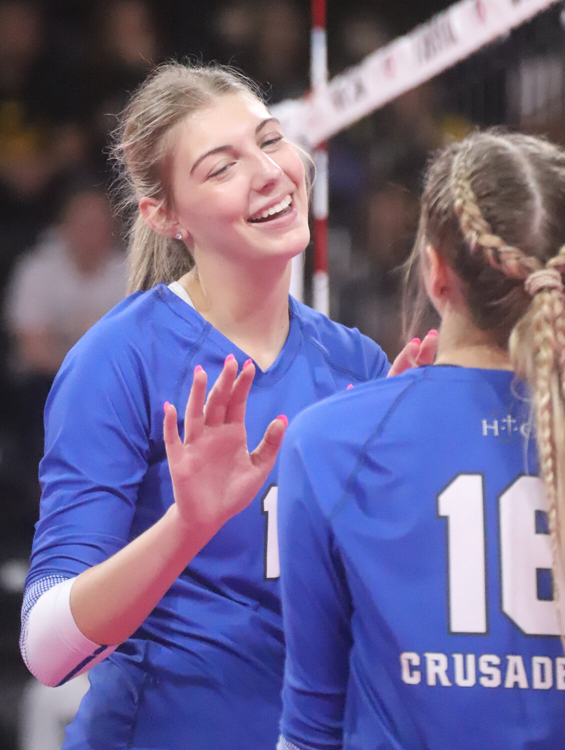Sophomore Presley Myers celebrates a kill with Taegan Denning in the second set Wednesday at the Class 1A semifinals in Coralville.