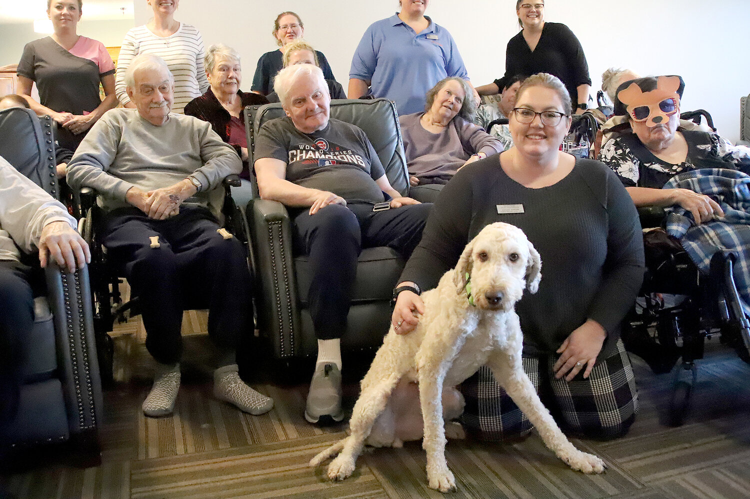 Residents at the Montrose Health Center pose with their new facility dog Nova, officially donated to the facility by PAW Animal Shelter Wednesday.