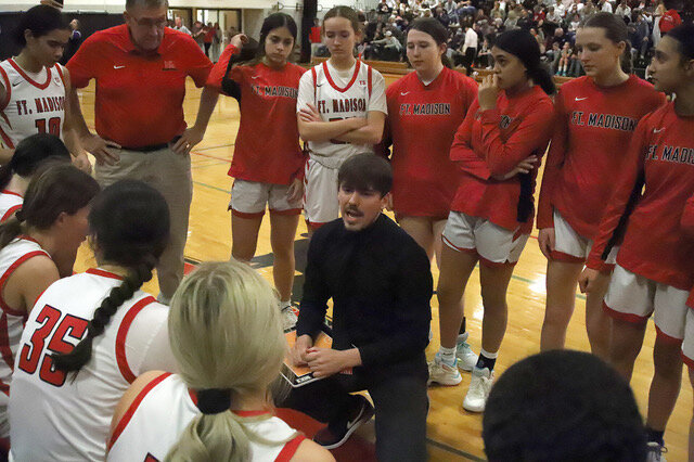 Fort Madison Head Coach Landon Bentley gives some instruction during a time out during the fourth quarter as the Hounds mounted a rally late that came up short.