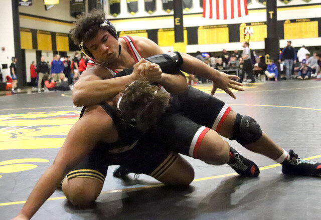 Junior Cory Arnett gets control of Bettendorf's Aiden Lee in the heavyweight title match in the 3A district qualifier at Bettendorf High School. Arnett would hang on for the win and the title and qualify for his first-ever state tournament.