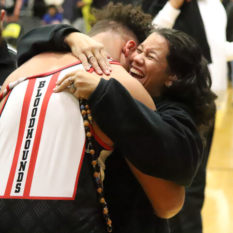 FMHS Senior Cory Arnett gets a hug from his mother after winning the heavyweight division at Saturday's state qualifier in Bettendorf. Arnett will wrestle starting Wednesday in the tournament in Des Moines.