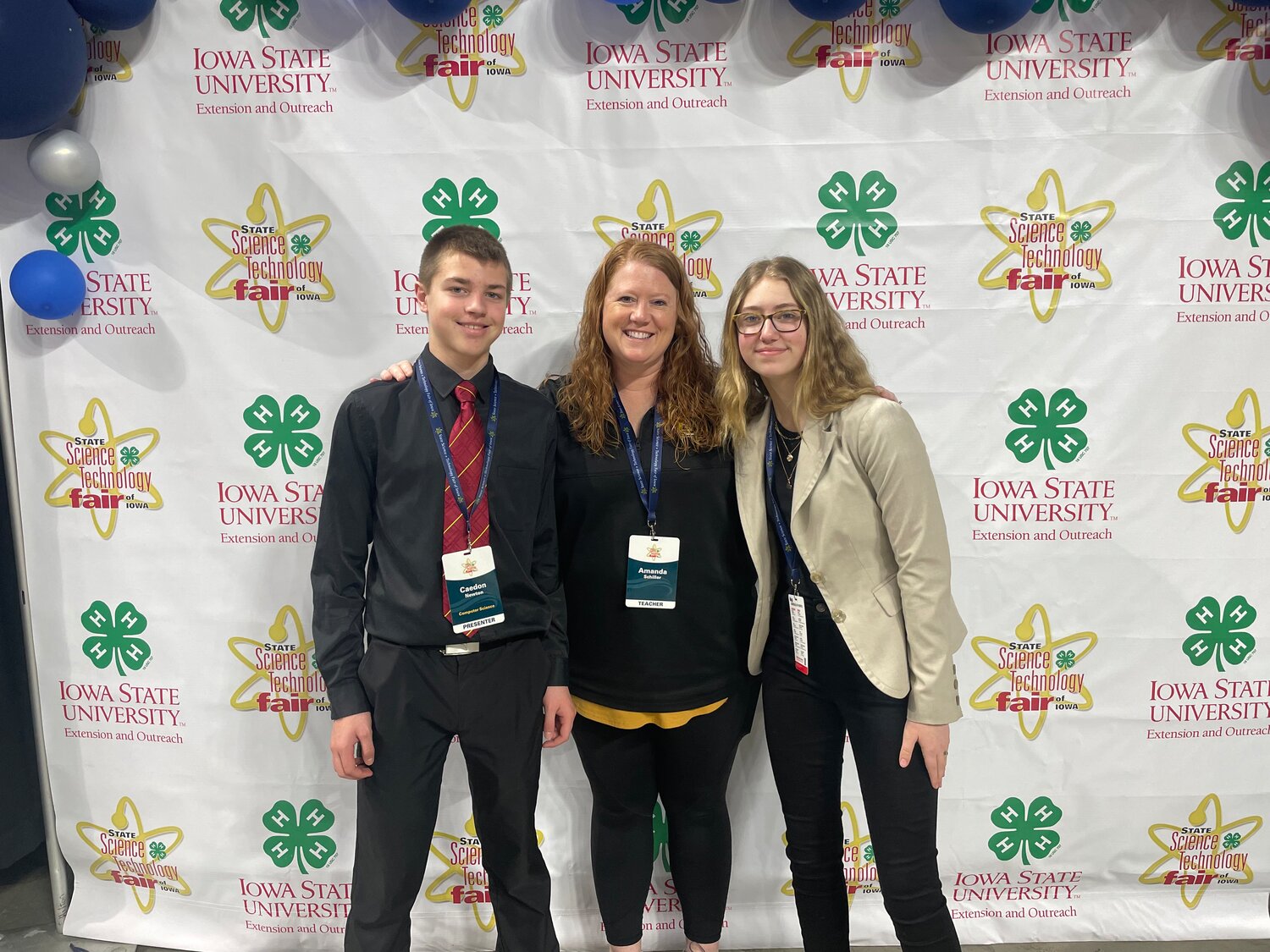 Central Lee 8th graders Caedon Newton, left, and Addison Hohl, right, pose with Central Lee science teacher Amanda Myhre at a recent STEM event. The two students have been selected to present their projects at a national symposium in Washington D.C. next month.