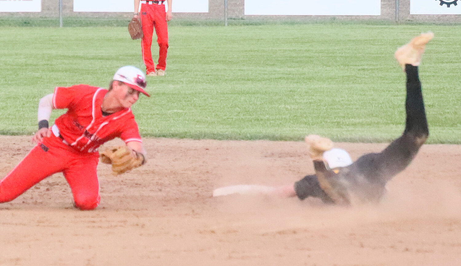 Central Lee's Blake Davis takes a wide slide into second after stealing the base in the top of the 2nd innings of the Fort Madison v. Central Lee baseball game Monday night. The Hounds won 2-1 to start the year 3-0.