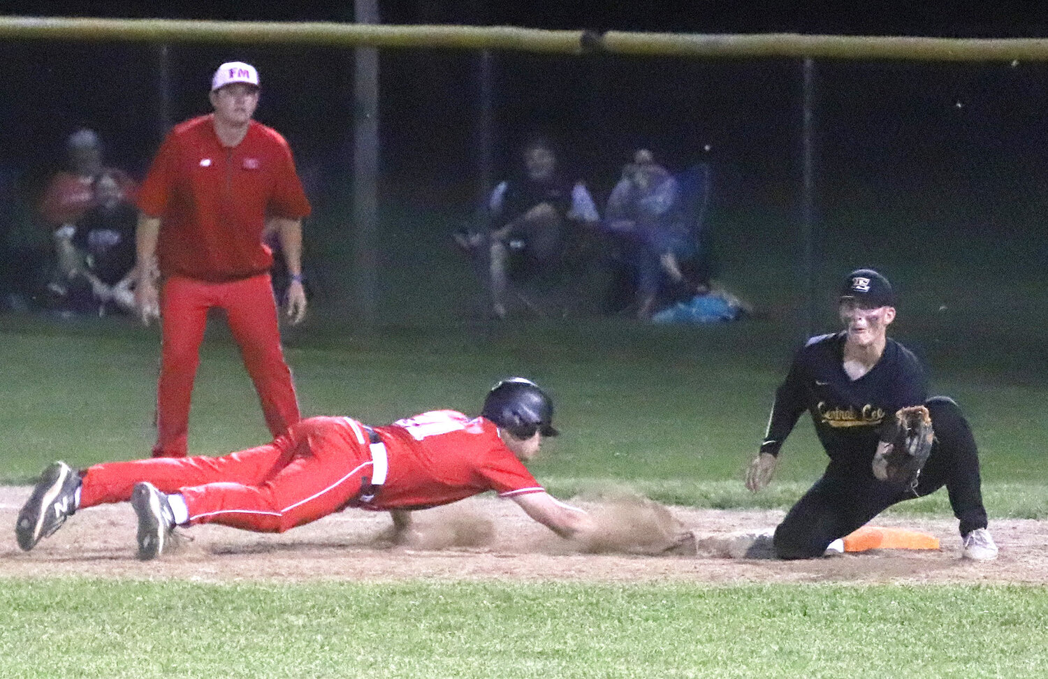 The Bloodhounds' Luke Hellige dives back into 1st base on a pick-off attempt in the bottom of the sixth. The Hounds would score the go ahead run in that half when Central Lee bobbled an infield pop-up.