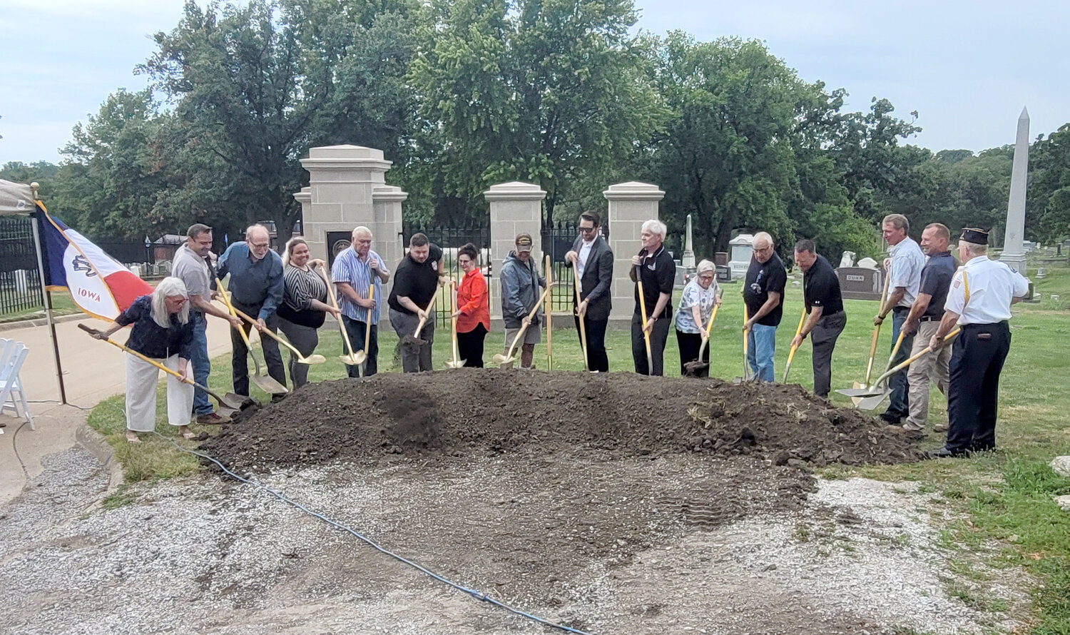 Dignitaries toss dirt as part of the ground breaking ceremony Friday at the Keokuk National Cemetery.