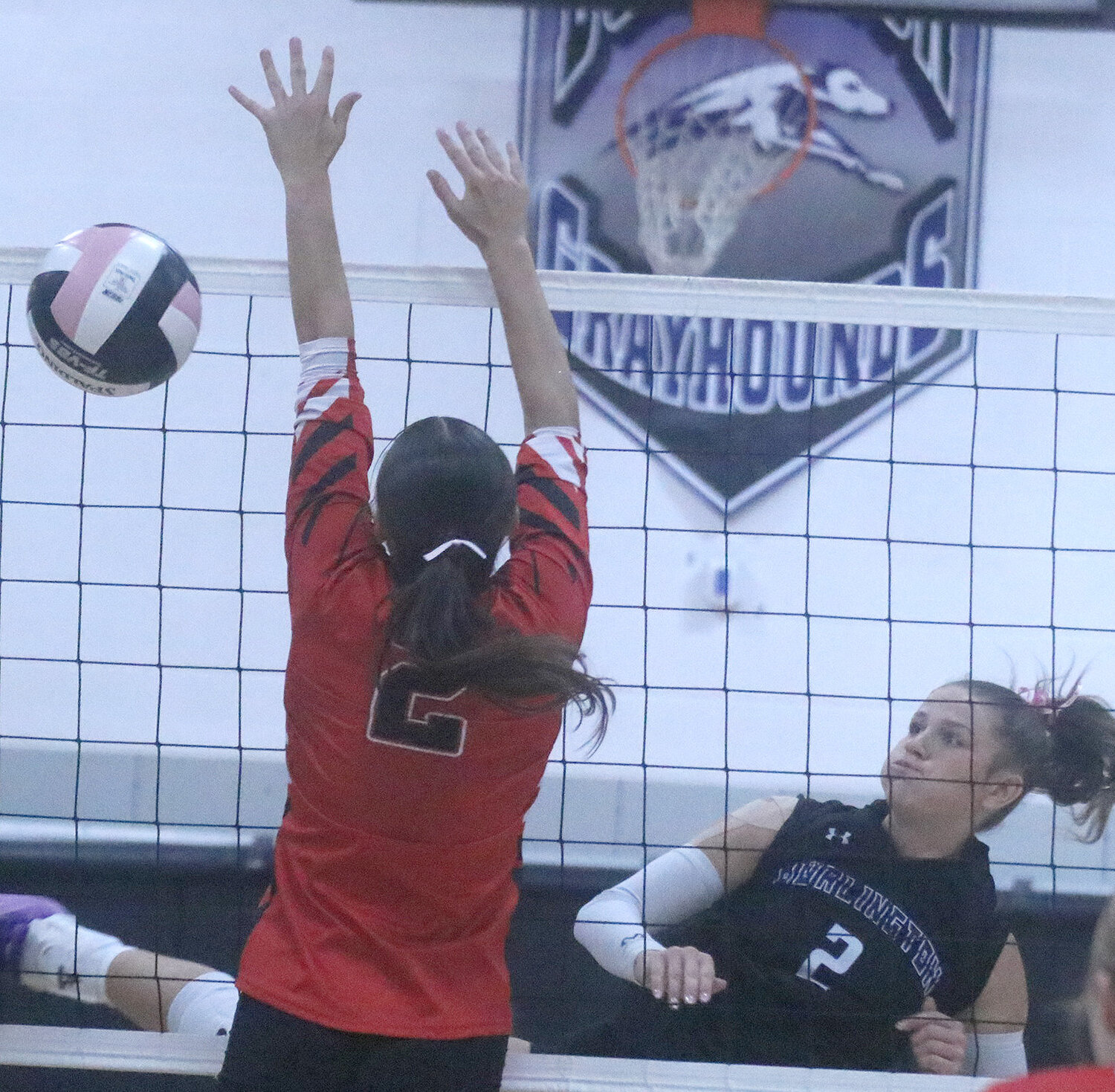 Junior Mara Smith (2) just misses on a block in the second set Tuesday night at the Hound Dome. The Hounds fell 25-13, 25-11, 25-12 to Burlington in the Hounds' final Southeast Conference regular season matchup.