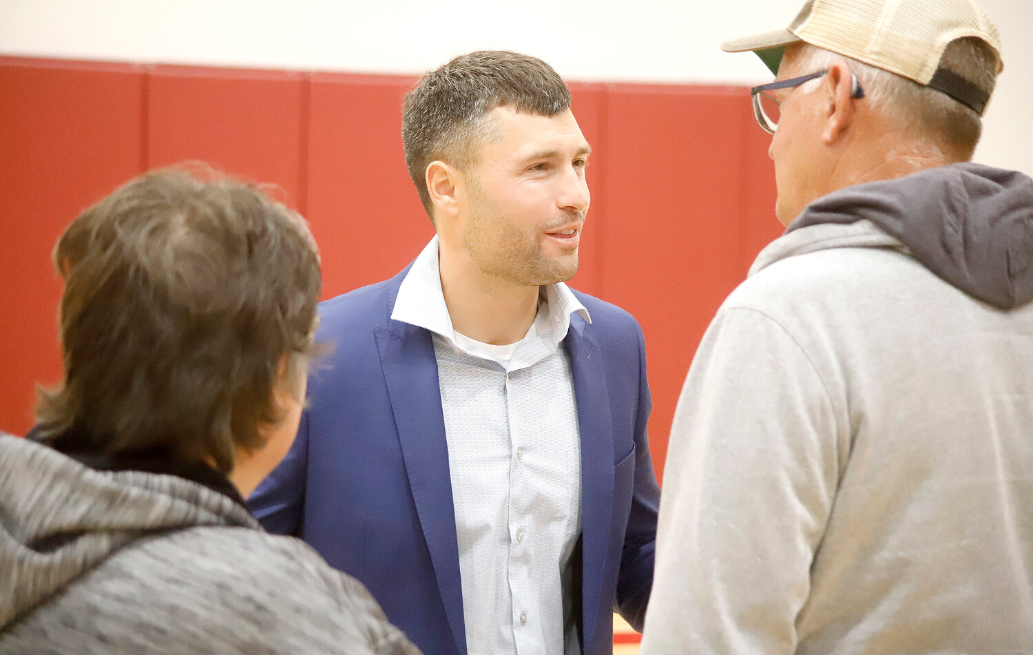 Lee County Sheriff candidate Elliott Vandenberg spends some time with potential voters Tuesday night at Fort Madison High School following a debate with incumbent Sheriff Stacy Weber.