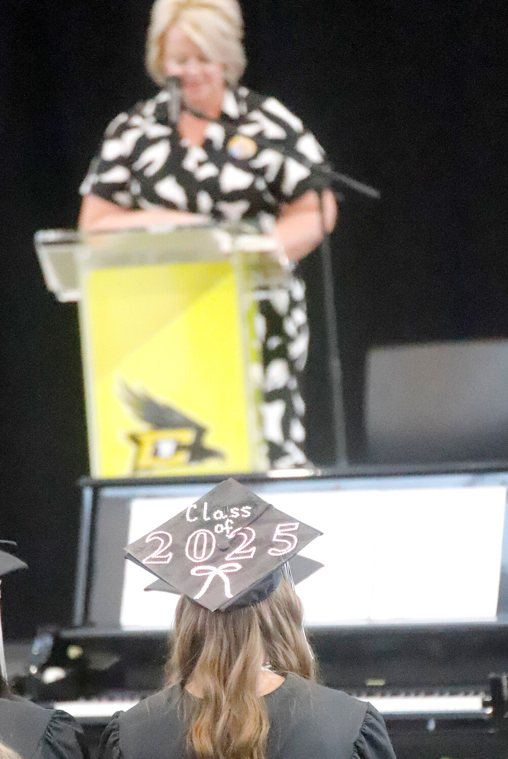 A graduate with the Central Lee Class of 2025 emblazoned on her mortarboard listens to Central Lee High School Principal Nicole Herdrich congratulates seniors at Sunday's commencement exercise.