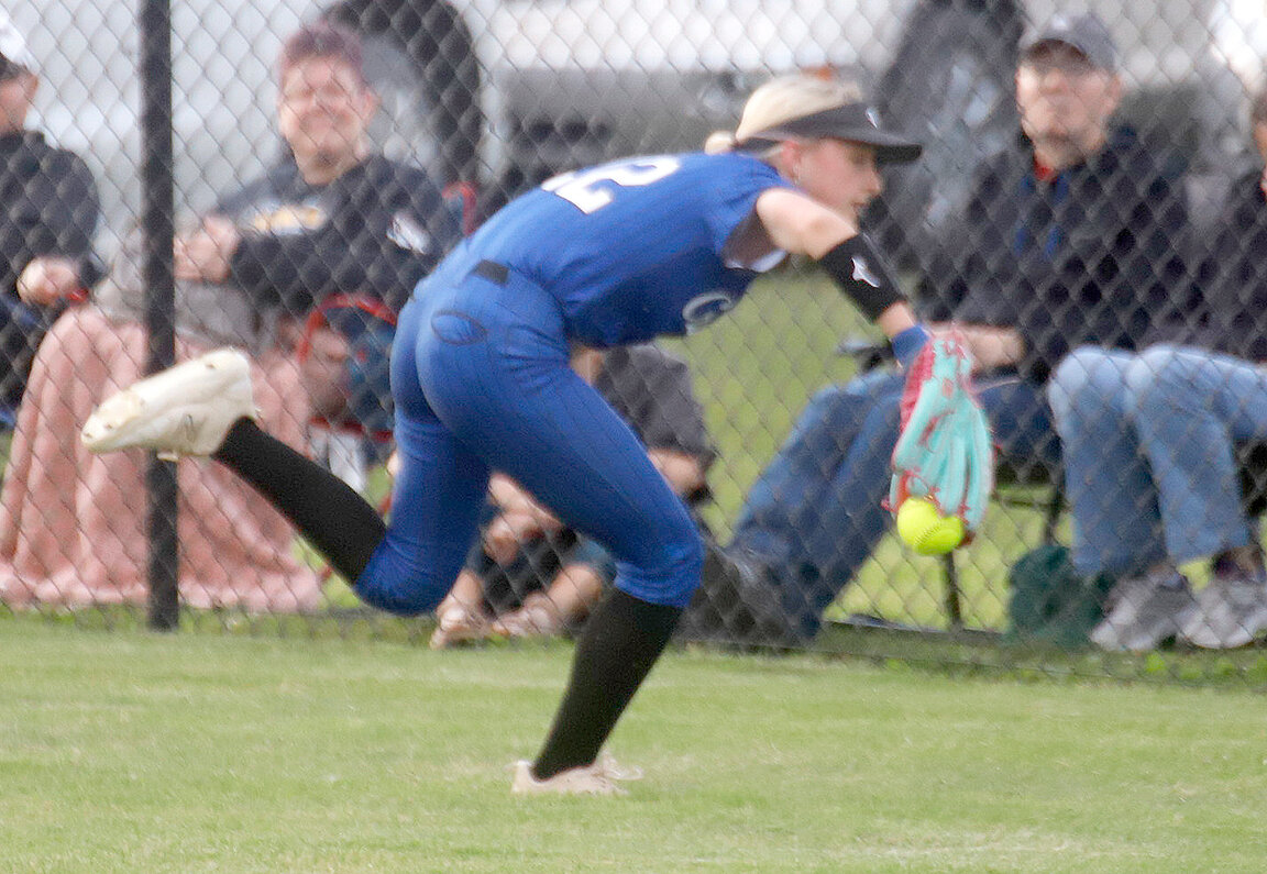 Holy Trinity's Kenna Gittings (22) almost drags down a line drive in right field in the bottom of the first inning. Gittings got to the ball on the full run but it slipped out of her grip at the last moment allowing a run to score..