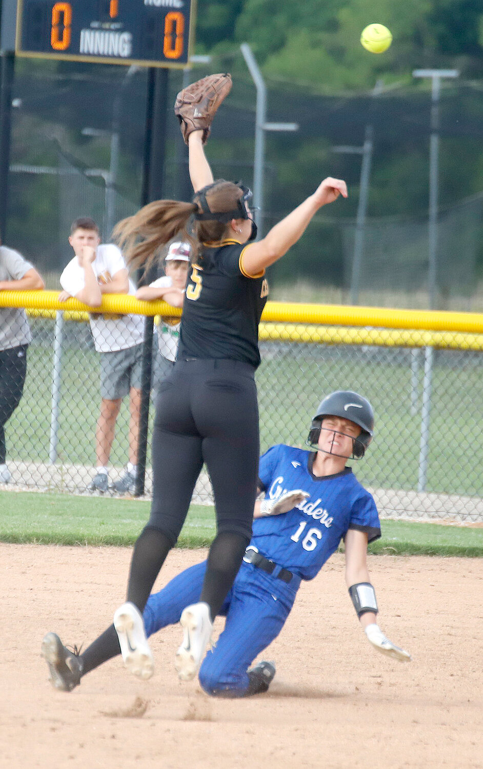 Holy Trinity Catholic's Kara Lake slides into second under a high throw taken by Central Lee's Jaci Hawk in the top of the second inning. Central Lee won 6-1 and advances to 3-0 on the year. The loss was Holy Trinity's first of the year.