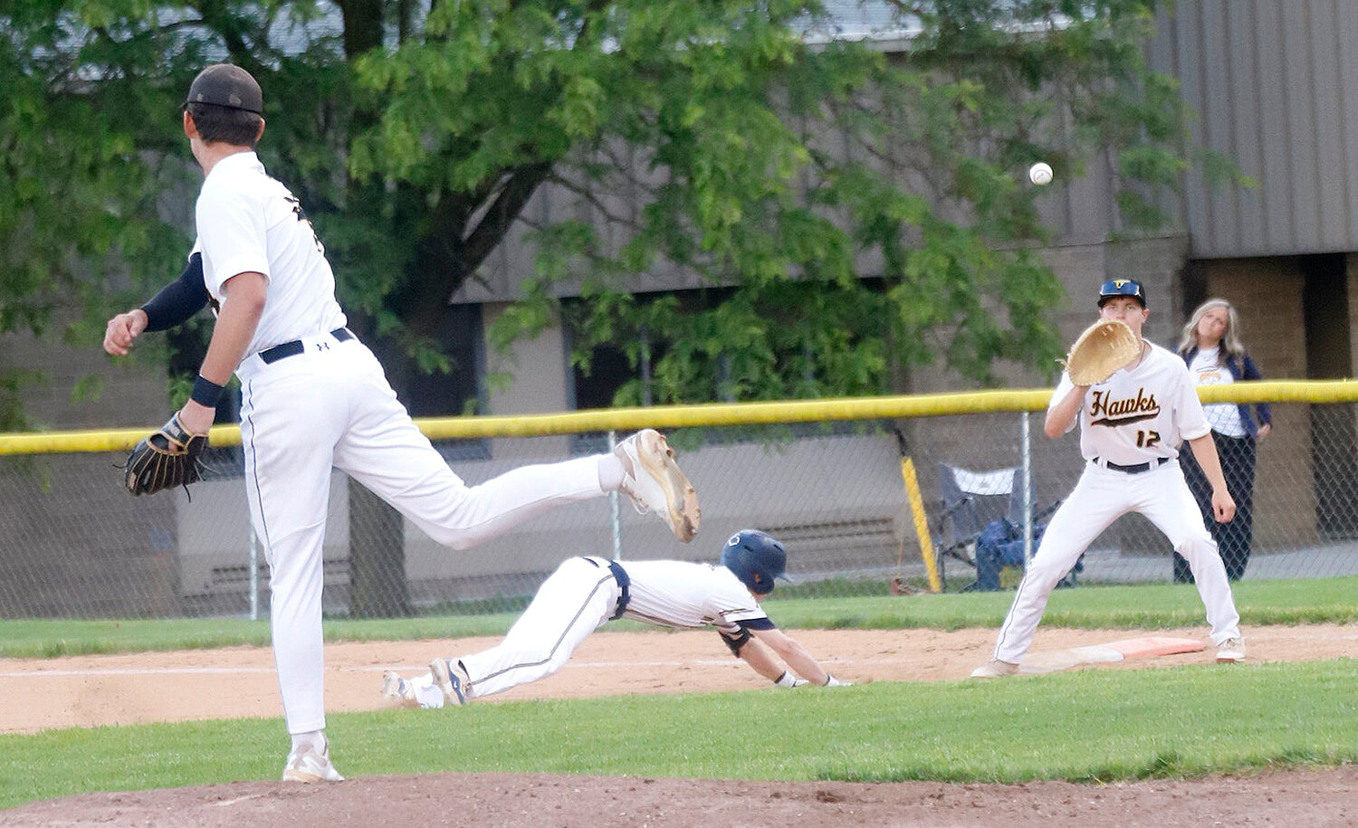 Central Lee's Bo Herdrich throws over to first as a Nike dive back to the bag in the second inning of Thursday's 15-1 loss to Burlington Notre Dame.