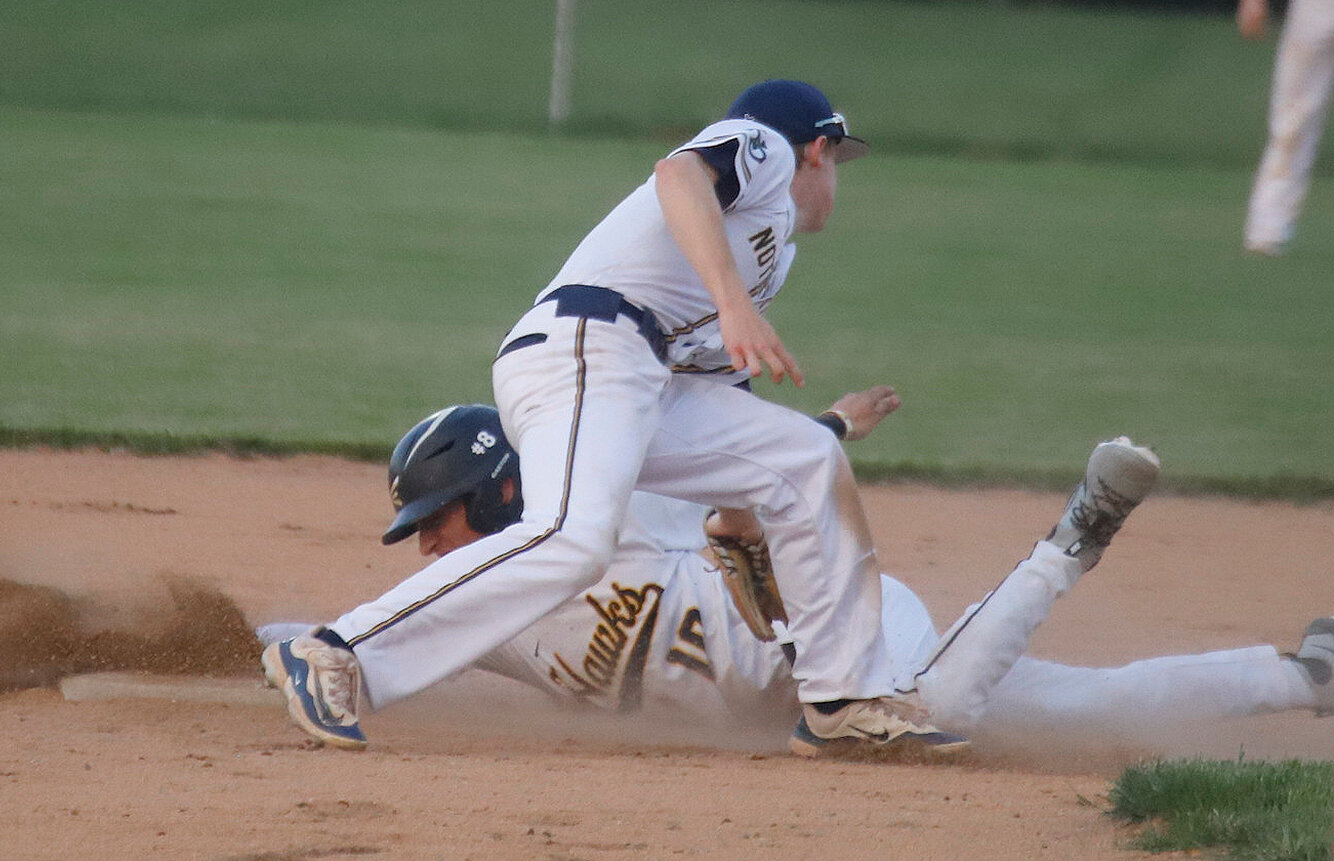 Central Lee's Hunter Edlin slides safely into second base under the tag of the Nikes' shortstop in the bottom of the second inning at Central Lee High School Thursday night.