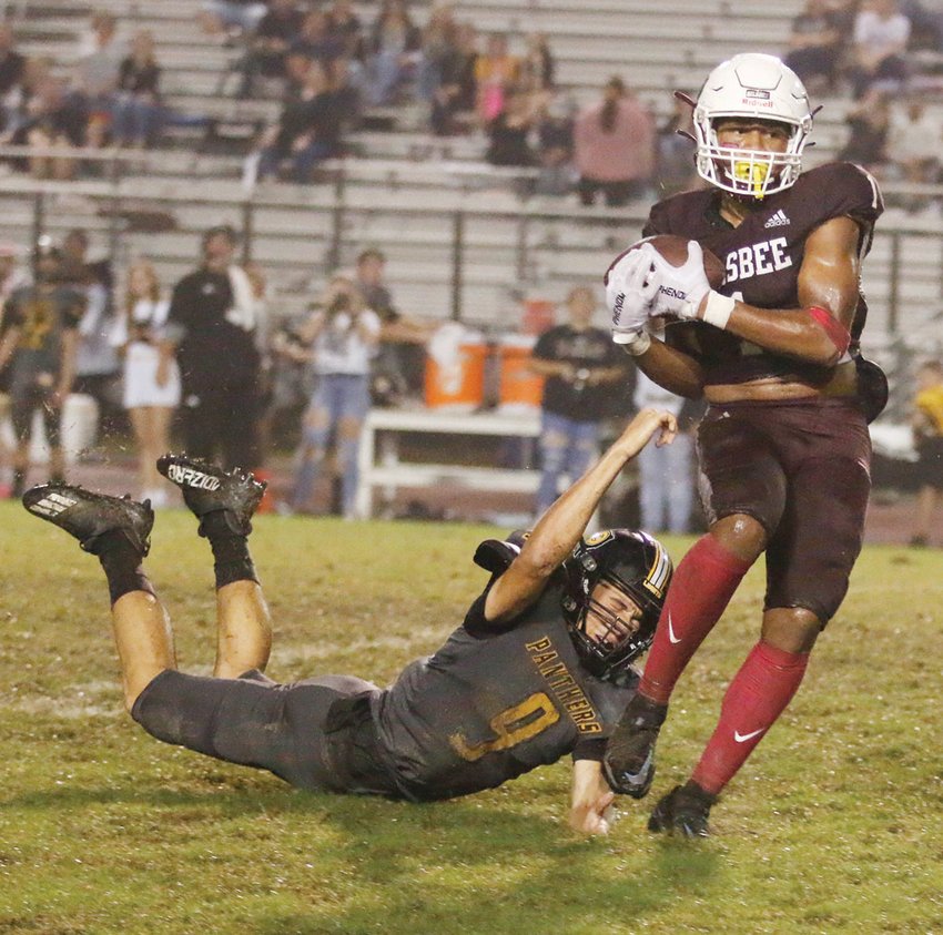 Silsbee wide receiver Dre'lon Miller (1) holds onto the ball after catching a pass from quarterback Mason Brisbane. Liberty's Mason Goudeau (9) failed to tackle Miller which resulted in an 84-yard TD in the third quarter.
