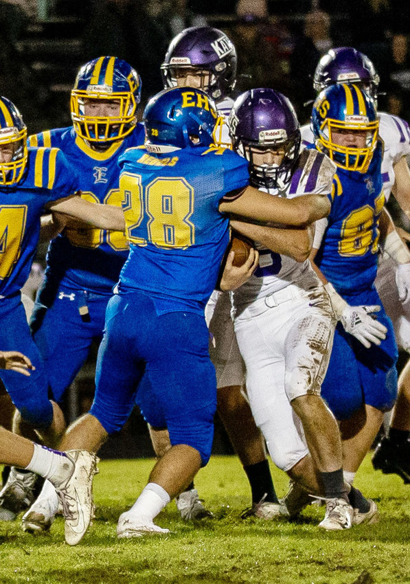 Evadale linebacker Trenton Lyles (28) and a host of Rebel defenders converge on a Cushing ball carrier.
