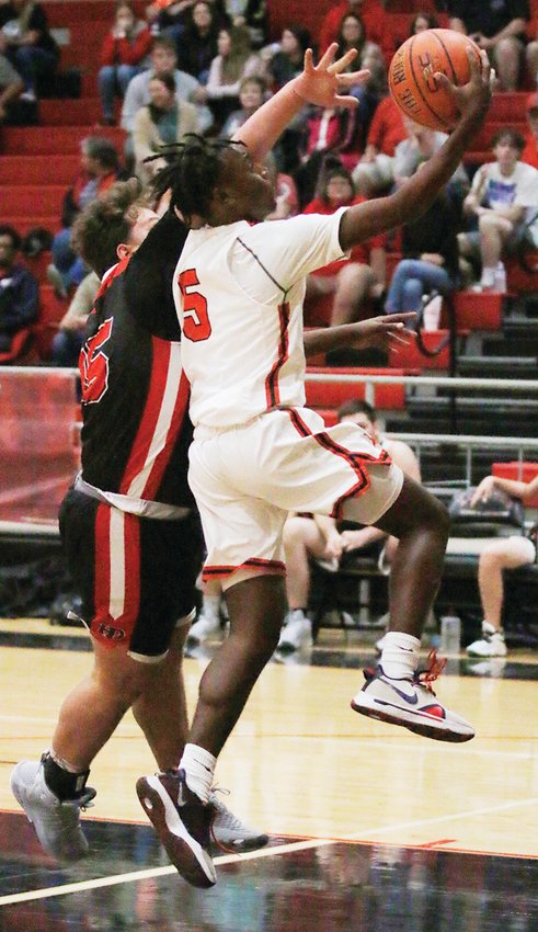 Zach Sells (5) of Kountze drives past a Hull-Daisetta player for 2 of his game-high 24 points in the Nov. 23 win at home.
