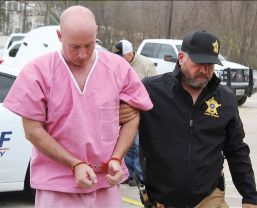 Adam Isaacks (left) , who is charged with indecency with a child, is escorted into the Jasper County Jail on Dec. 31 by JCSO Chief Deputy Scotty Duncan (right).