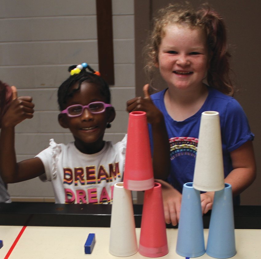Miyah Westbrook and Kayleigh Quast work together at stacking.