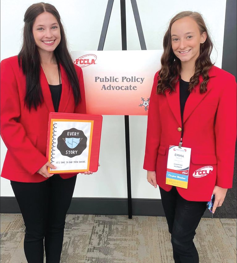Kennedy Blincoe and Emma Hayes posing with their project, Every Story at the FCCLA National Convention in San Diego.