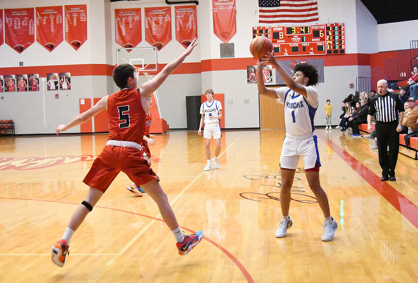 Harrisonville senior Dom Jackson (1) shoots a 3-pointer over a Hume defender during last week's Archie Tournament.