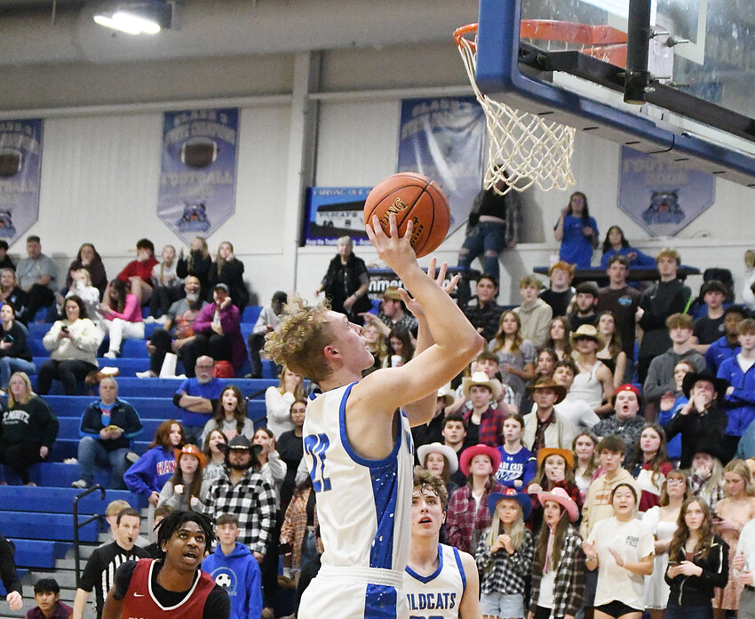 Harrisonville senior Mason Worthley scores an open layup with 32 seconds left in Friday’s victory over Warrensburg. Worthley scored a layup, blocked a shot and grabbed a key offensive rebound during the final minute of the Wildcats’ 57-47 win.