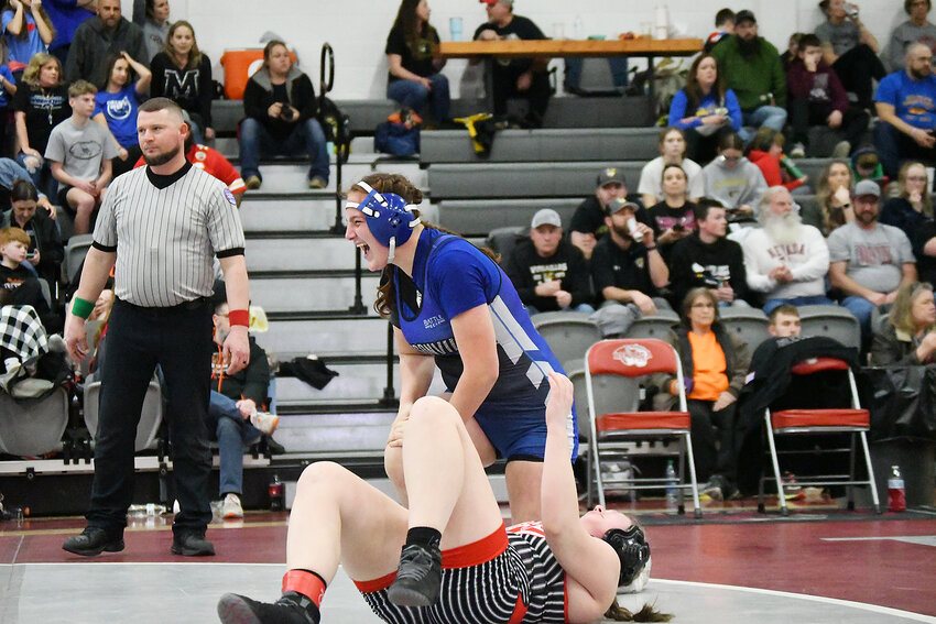Harrisonville freshman Taylor Kanoy celebrates her win over El Dorado Springs’ Lillian Corbin in the “blood round” consolation semifinals Saturday. Kanoy’s pin in 51 seconds clinched her state berth. Kanoy finished fourth in the 170-pound bracket at the Class 1 District 3 tournament in Nevada.