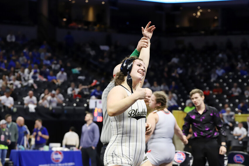 Adrian sophomore Annabelle Rowe gives a thumbs up to the Blackhawk crowd following her win in the 235-pound championship at the state wrestling tournament last Thursday. Rowe became the first Adrian girl to win a state wrestling title.