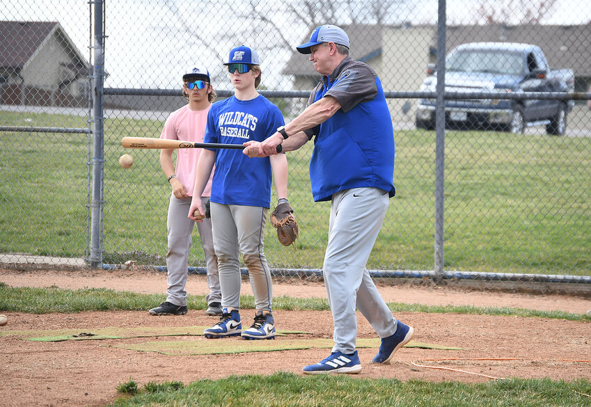 Harrisonville baseball coach Jeff Langrehr, right, hits an infield ground ball during a defensive drill at practice last week. The Wildcats will be young and relativelly inexperienced this week, but Langrehr feels good about his squad entering the season.