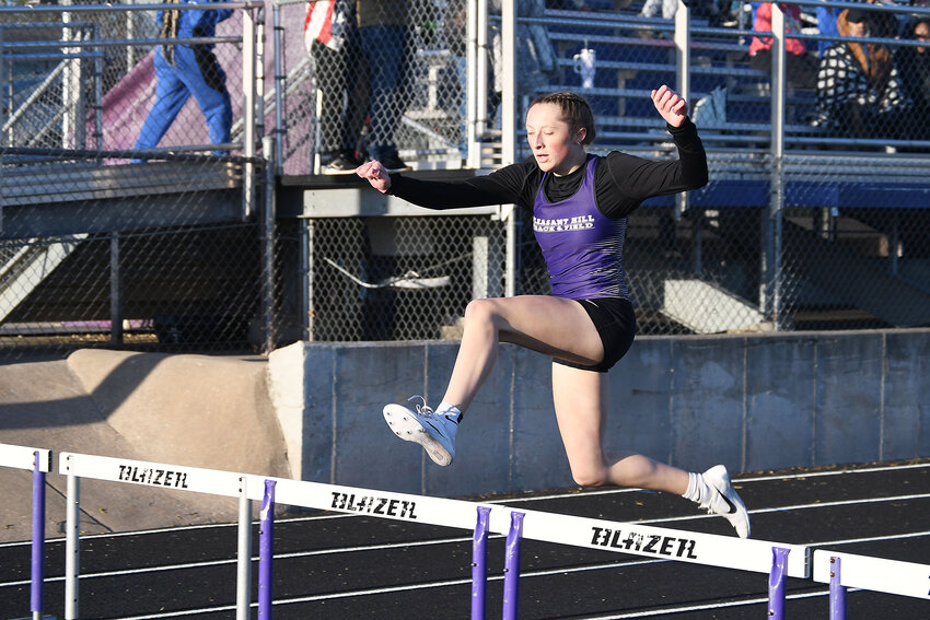 Pleasant Hill sophomore Laura Irwin clears the final hurdle during the 300-meter hurdles at a home meet last week.