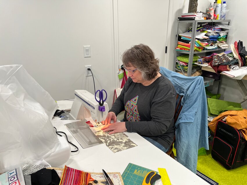 Denniele Bohannon of Harrisonville, works on sewing pieces of cloth together for a quilt. Bohannon owns Louanna Mary Quilt Design, and has found a love for quilting and the steps involved in the process.