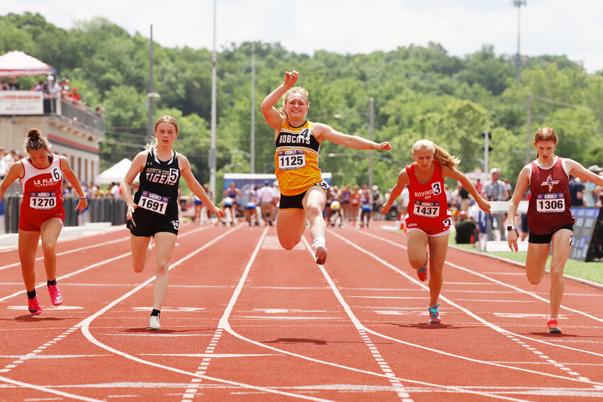 Drexel senior Josie Parks, center, jumps for joy after crossing the finish line as the Class 1 state champion in the 100-meter dash at the MSHSAA state track and field meet. It was Parks’ first individual state title after medaling in the event the past three years.