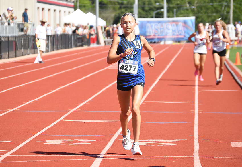 Harrisonville junior Kayleigh Norris cruises to victory, after passing lapped runners, and the 3,200-meter run state championship in a time of 10:35.54.