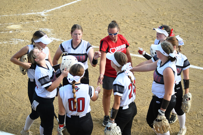 Sherwood softball coach Erin Doll talks to her team in between innings during a game last year.