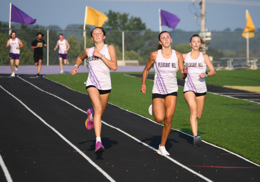 Members of the Pleasant Hill girls cross country team sprint to the finish of their mile race at the annual Purple and Gold Night. Pictured are Laura Irwin, Rowen Hays and Avery VanderVeen.