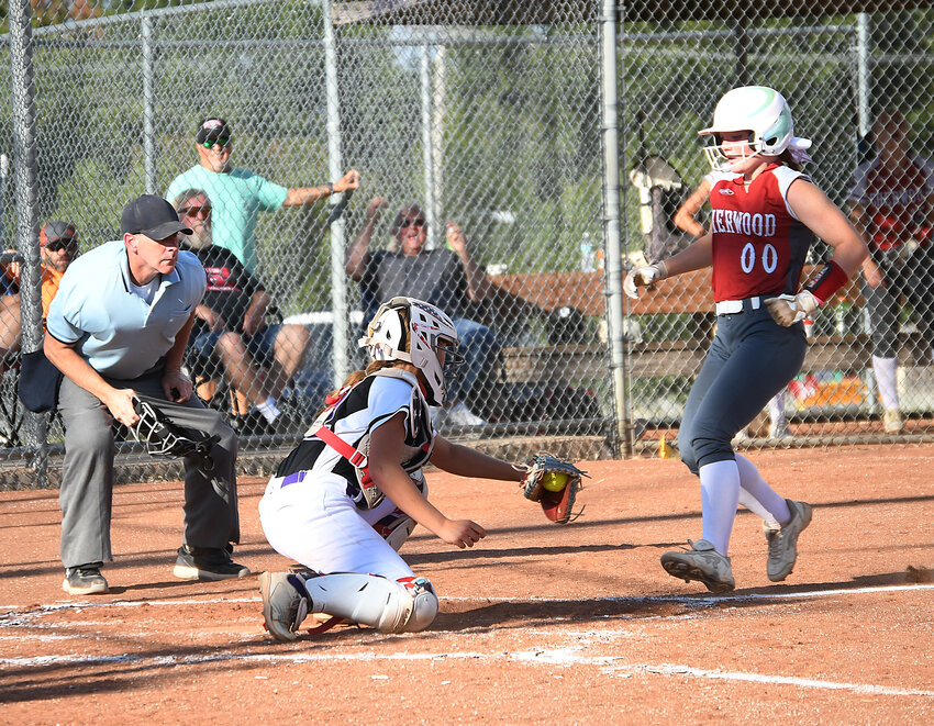 Pleasant Hill catcher JoeE Younce prepares to tag Sherwood's Lyah Powell for at out during Monday's game. Pleasant Hill won 13-3 in a five-inning, run-ruled contest.