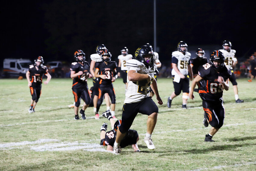 Drexel senior running back TJ Munter, center, runs away from Jasper defenders during one of his touchdown runs Friday night. Munter rushed for more than 200 yards in the Bobcats’ 48-14 victory.