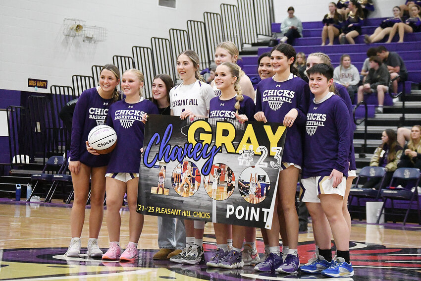 Pleasant Hill senior Chaney Gray, second from left, was honored before last week’s home game against Center for surpassing 1,000 points in her career. Gray was also one of three Chicks honored for senior night last Tuesday. The Chicks crushed Center, winning 75-44 in front of a large home crowd.